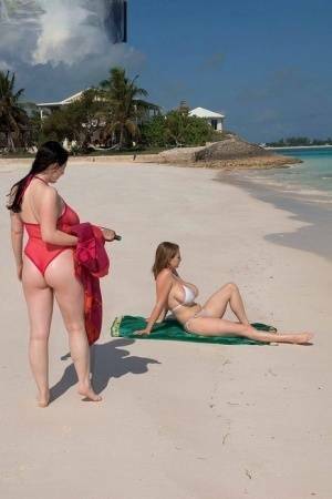 Busty lesbian girls let their huge knockers loose to kiss & lick on the beach on fangals.org