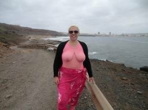 Aged lady Barby looses her big tits from a crotchless bodystocking by the sea on fangals.org