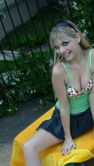 Young blonde Jana Jordan exposes her pretty bra and panties by a swimming pool - Jordan on fangals.org