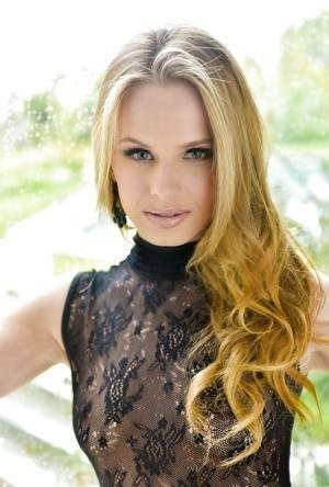 Blonde babe model Jillian Janson strutting outdoors in black bodystocking on fangals.org