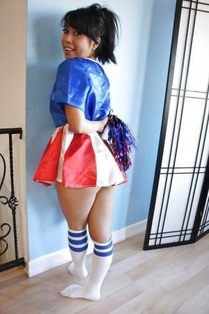 Tiny Asian cheerleader May Lee posing in cute uniform and socks on fangals.org