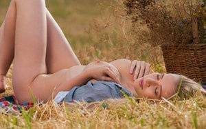 Blonde teen Penelope G displays her great body in a freshly cut farmer's field on fangals.org