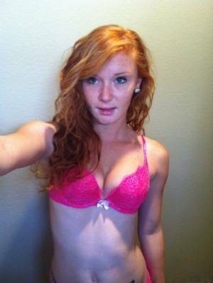 Natural redhead Alex Tanner slips off her pink lingerie set for nude selfies on fangals.org