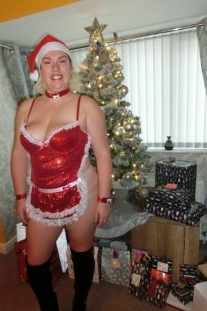 Busty blonde Barby masturbates her shaved pussy near the Christmas tree on fangals.org