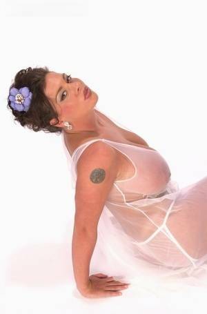 Buxom Linsey Dawn poses to flaunt her droopy tatas in sheer lingerie on fangals.org