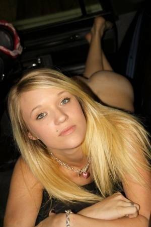 Blonde amateur Teagan slides lace panties aside to get naked inside a vehicle on fangals.org