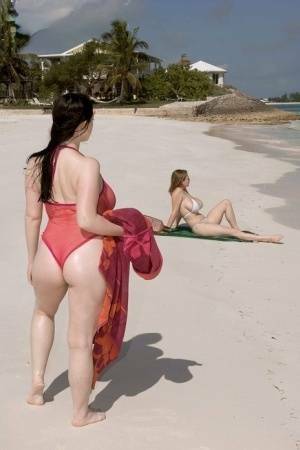 Plump female Christy Mark and her big boobed friend have lesbian sex on beach on fangals.org