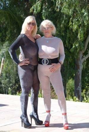 Mature blonde Melody and her lesbian lover bare their boobs on a building site on fangals.org