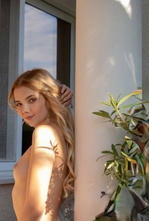 Young blonde Chanel Fenn shows her sexy ass while getting naked in a garden on fangals.org