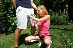 Young blonde girl Nicole Ray giving large dick oral sex outdoors on lawn on fangals.org