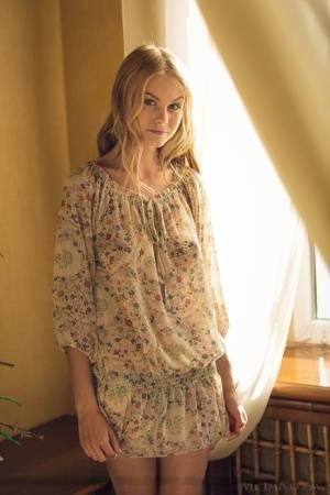 Cute blonde teen Nancy A slips off her floral dress to model naked on fangals.org