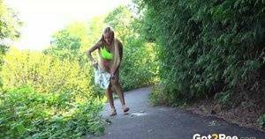 Blonde teen Daisy Lee takes a piss on a paved path through the woods on fangals.org