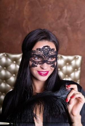 Sexy brunette Leyla Lee removes a mask and robes to pose nude with a feather on fangals.org