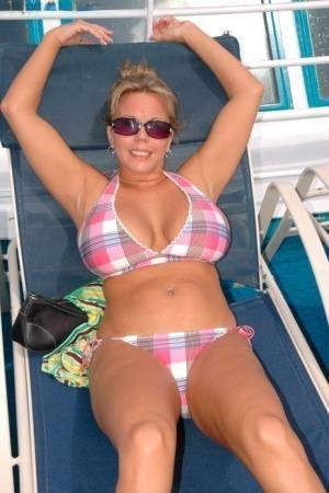 Hugely busty Amber Lynn Bach doffs her bikini to spread her legs wide nude on fangals.org