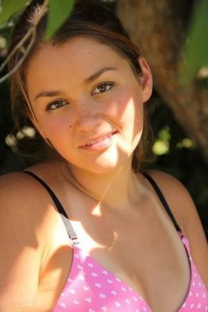 Petite amateur Allie Haze shows her tan lined body in the shade of a tree on fangals.org