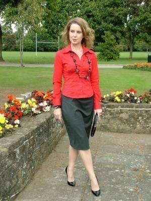 Fully clothed woman steps out of a stiletto heel while visiting a public park on fangals.org