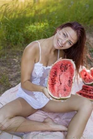 Sweet young girl gets naked while eating a watermelon under a tree on fangals.org