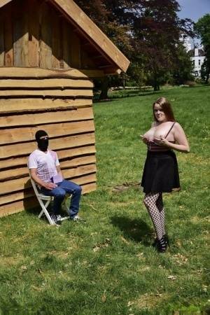 Natural redhead masturbates on a lawn before teasing a masked man on fangals.org