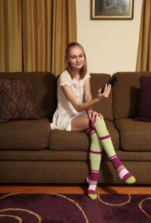 Adorable teen Alicia Williams takes a selfie before getting naked in OTK socks on fangals.org