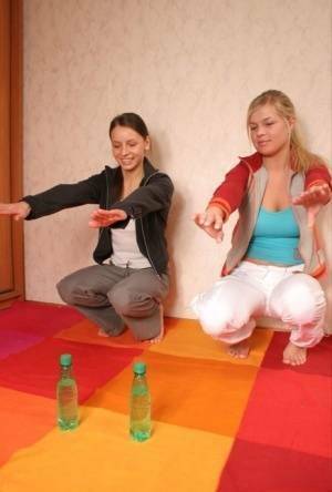 Young blonde uncovers her big tits while stretching out next to a girlfriend on fangals.org