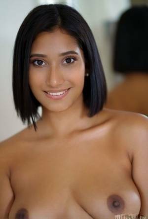 Beautiful Latina teen Alika Penagos gets totally naked on a chair on fangals.org