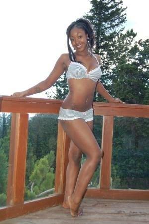 Black girl Amber uncups her big tits while getting in an outdoor hot tub on fangals.org